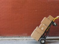 shipping-boxes-in-front-of-red-brick_925x